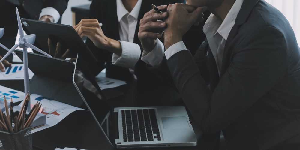 Close up of Business team analyzing income charts and graphs with modern laptop computer. Business analysis and strategy concept.